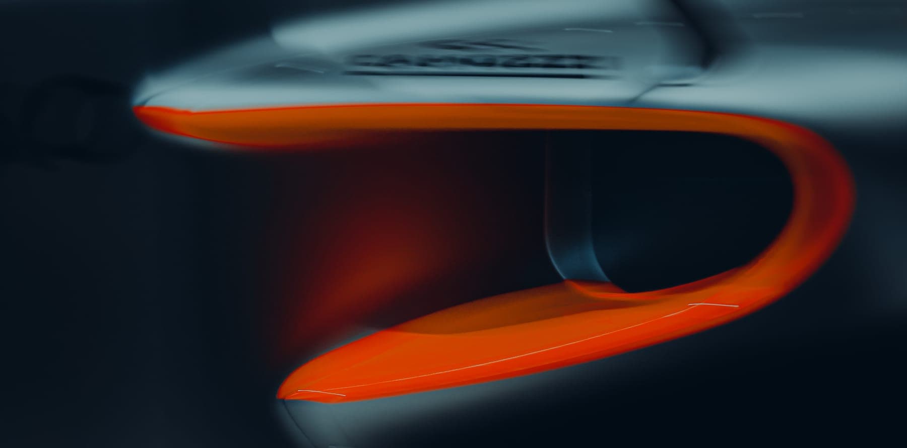 Close-up of an orange aerodynamic element in motion.