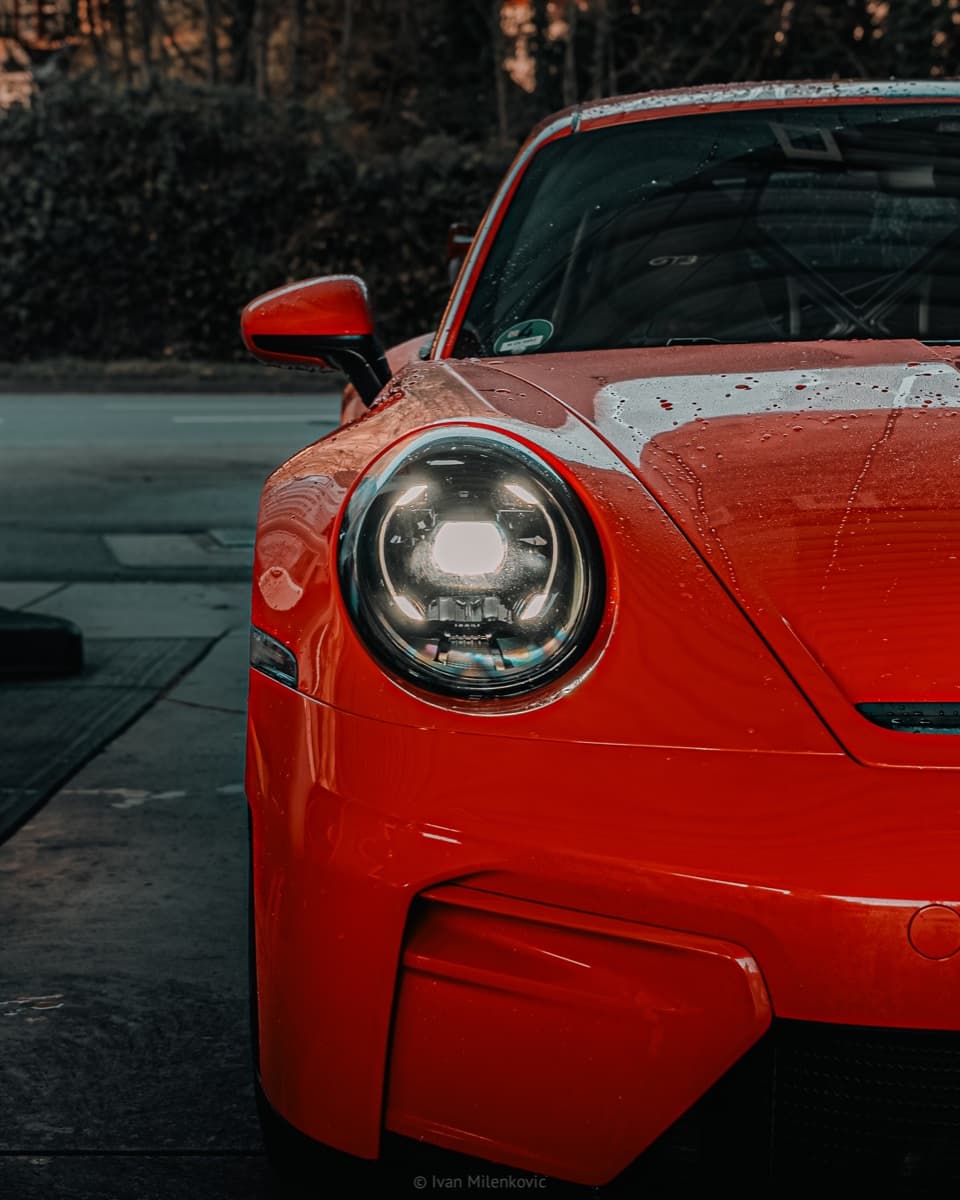 Close-up of a Porsche 911 GT3 headlight in the evening light.